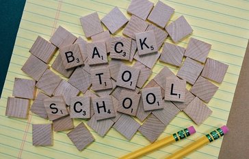 back to school spelled in game tiles