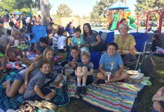 kids and parents smiling on blankets